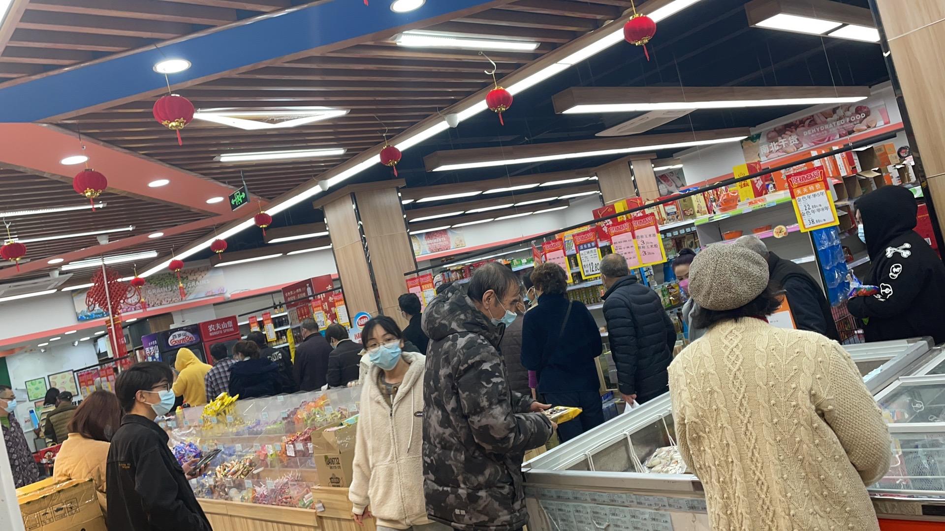 The small supermarket is crowded with people